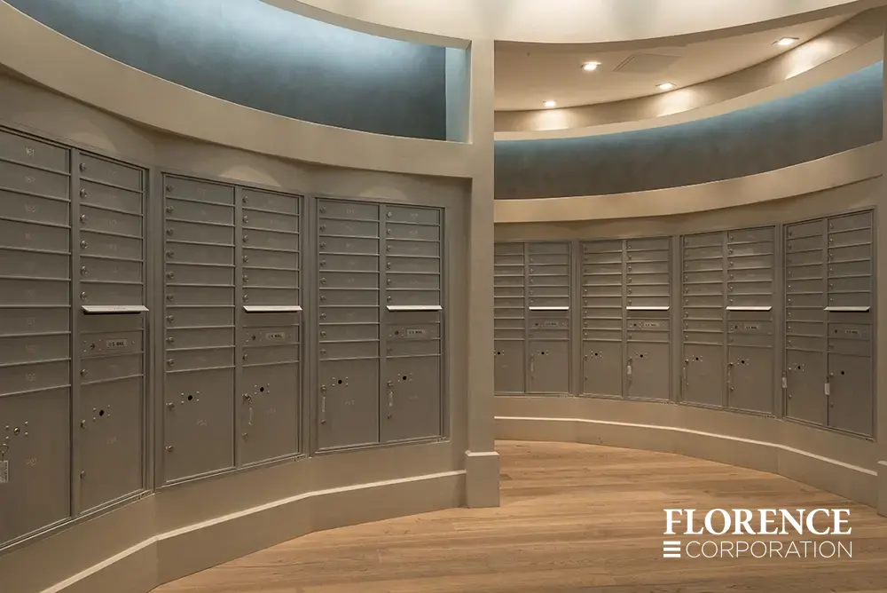 multiple curved rows of recessed mount versatile™ 4C mailboxes in silver speck installed in modern apartment mailroom