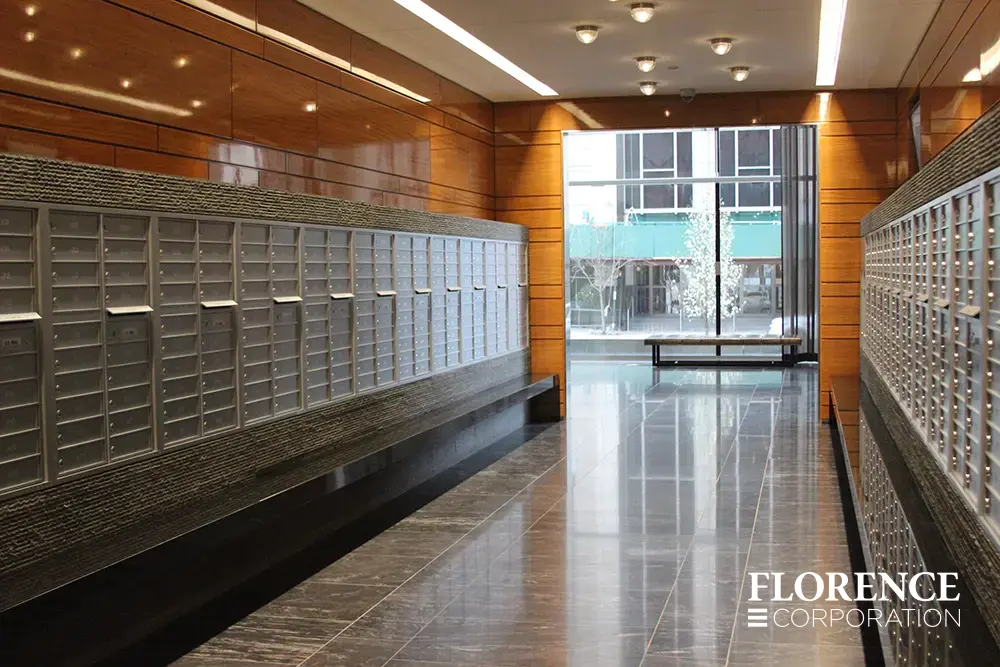 Recessed mount versatile™ 4C mailboxes in silver speck installed inside modern apartment lobby area