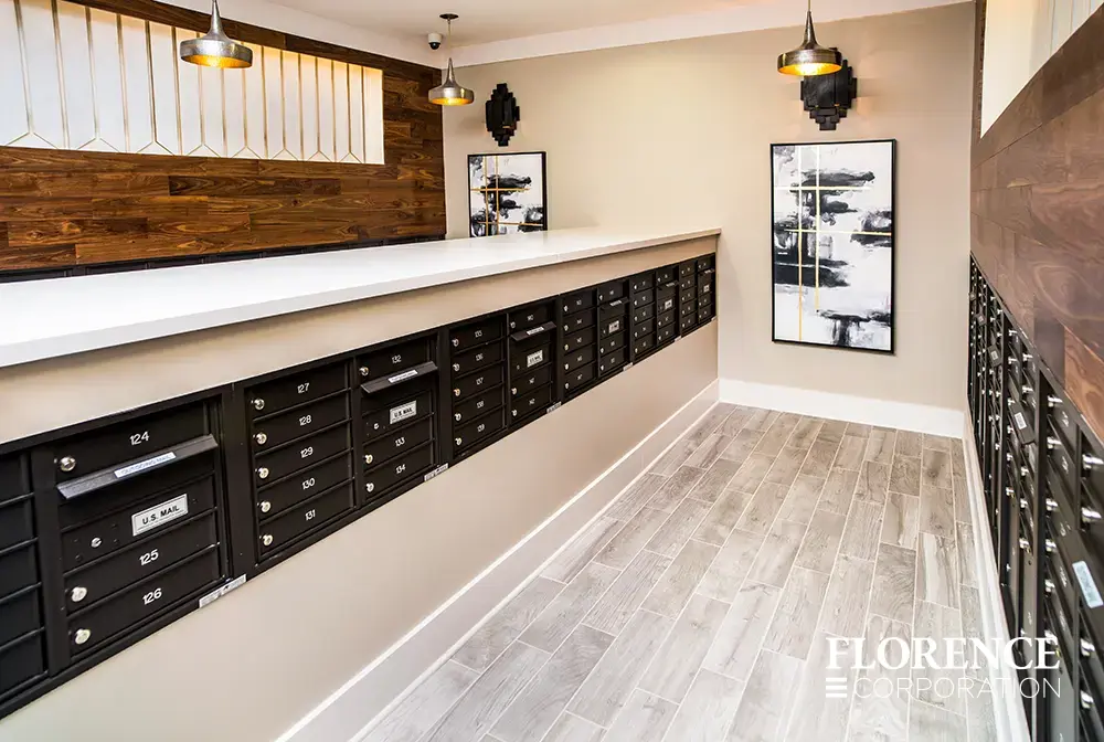 Recessed mount versatile™ 4C mailboxes in black installed indoor in modern multifamily mailroom