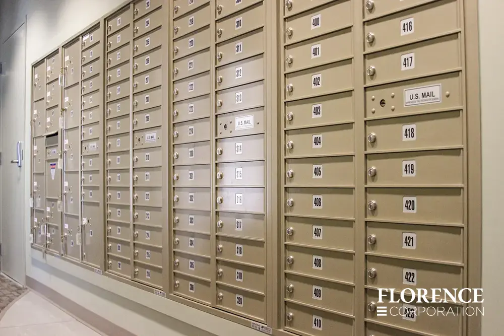 Recessed mount versatile™ 4C mailboxes in sandstone installed in wall in multifamily apartment building