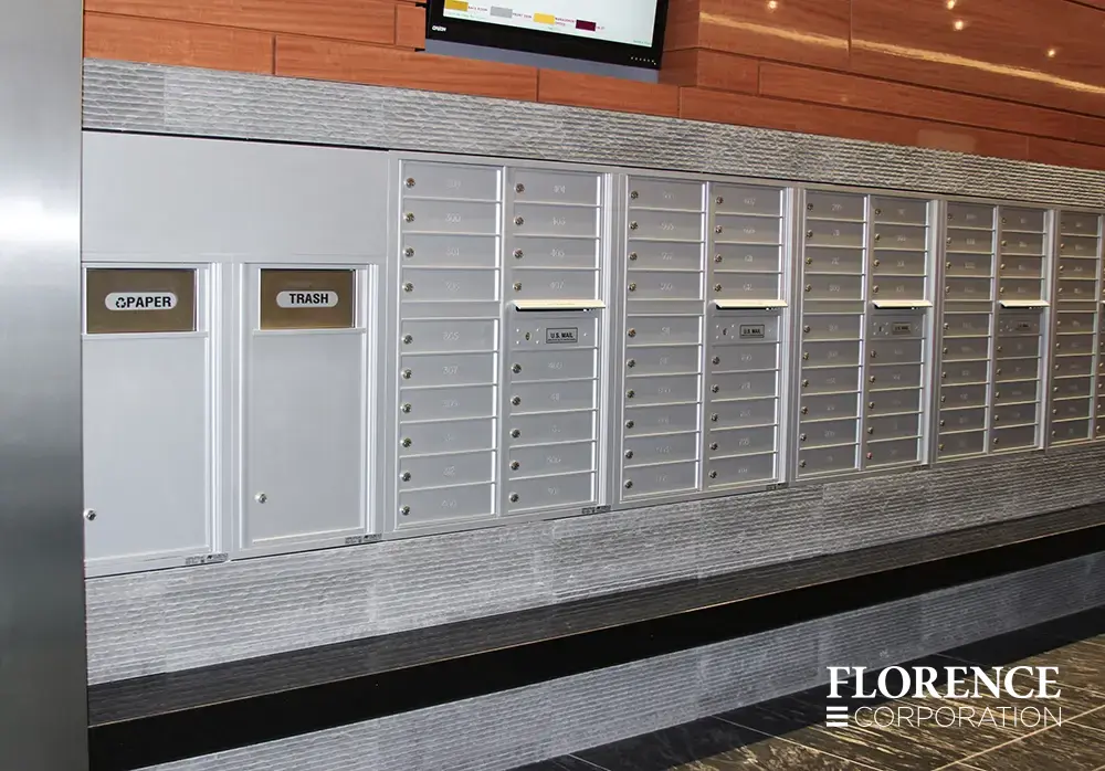 Recessed mount versatile™ 4C mailboxes and bins in silver speck installed in commercial building space trimmed with gray stone over black ledge