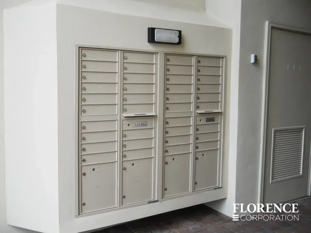 recessed mounted versatile™ 4C mailboxes in sandstone installed outdoor recessed in white wall