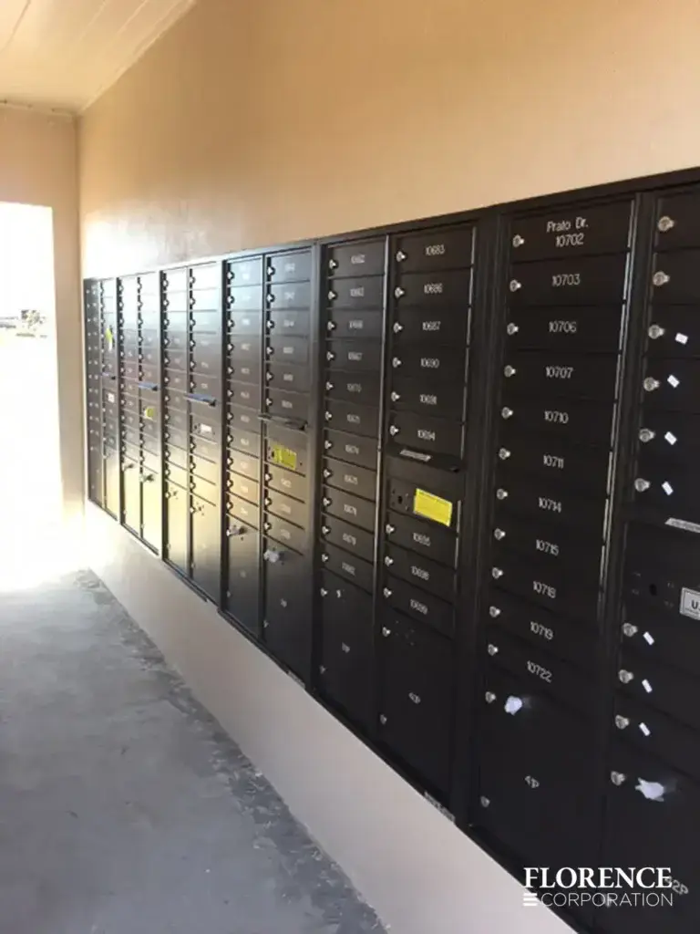 recessed mounted versatile™ 4C mailboxes in black mounted in wall of multifamily community breezeway