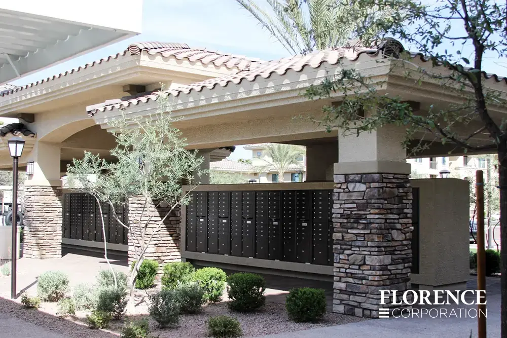 recessed mounted versatile™ 4C mailboxes in black under tile covered center with stone columns