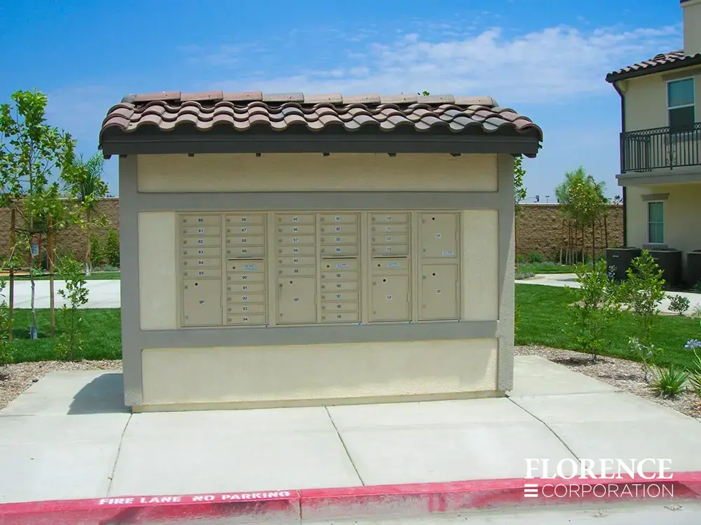 recessed mounted versatile™ 4C mailboxes in sandstone mounted into cream stucco building with spanish tile roof