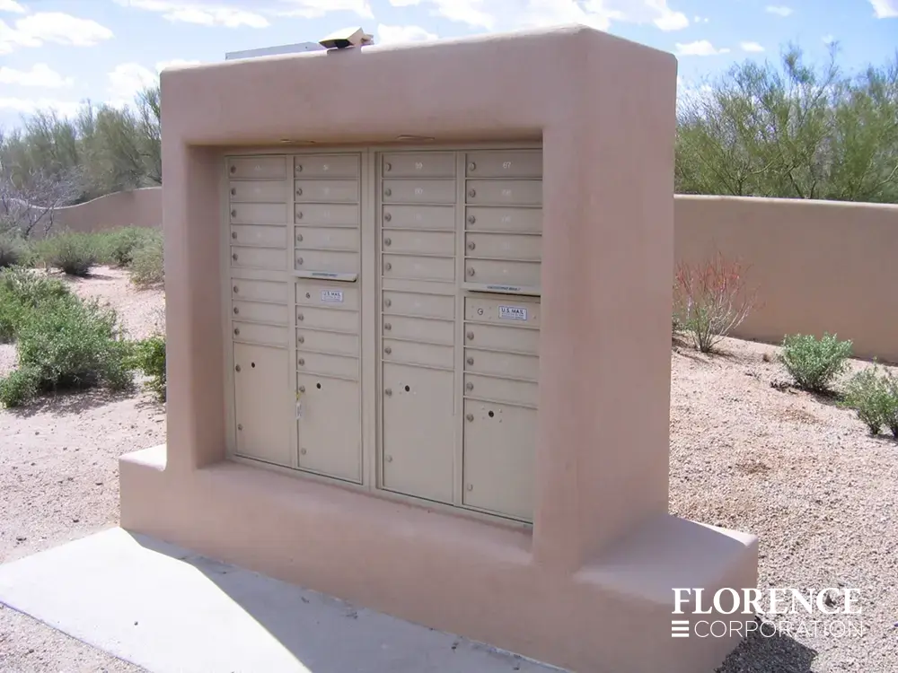 recessed mounted versatile™ 4C mailboxes in sandstone installed in clay stucco fixture with rock landscaping