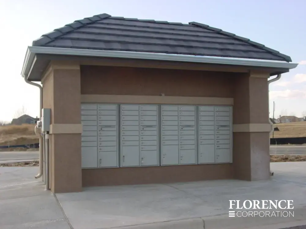 recessed mounted versatile™ 4C mailboxes in silver speck installed under covered fixture in new development lot