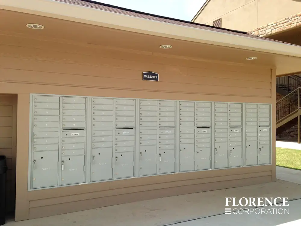 recessed mounted versatile™ 4C mailboxes in silver speck installed outdoors on side of multifamily community building