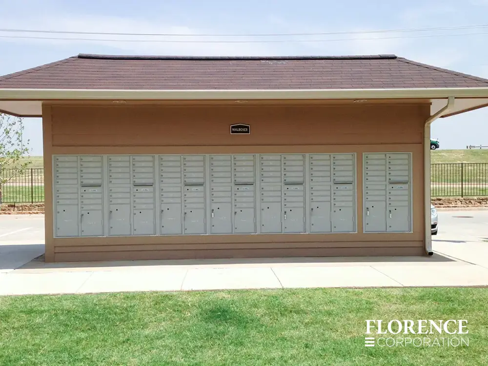 recessed mounted versatile™ 4C mailboxes in silver speck installed on outside of tan multifamily community building