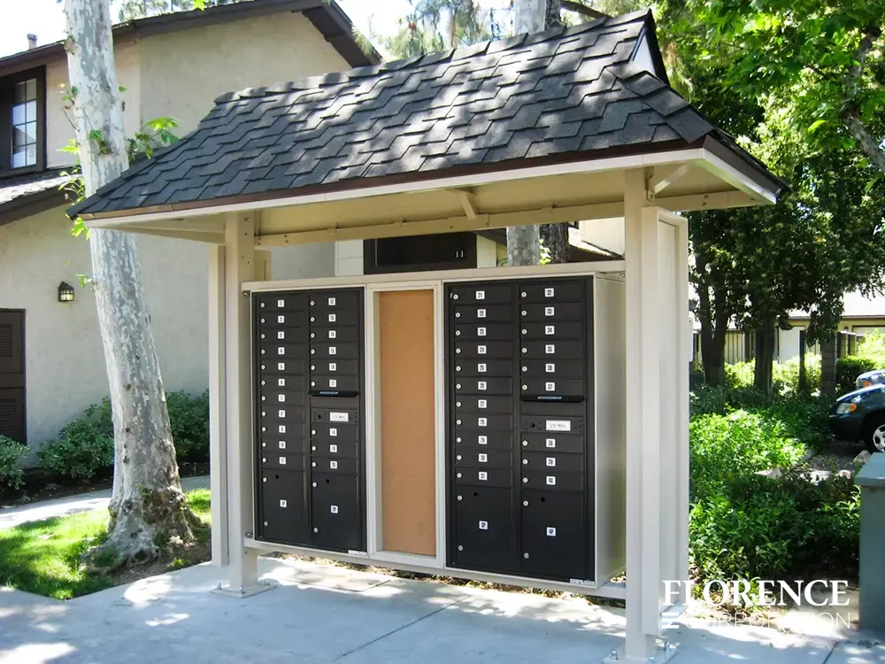 recessed mounted versatile™ 4C mailboxes in black installed outdoor in sandstone metal covered fixture near parking lot of townhome community