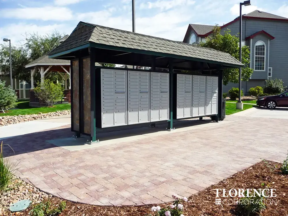 recessed mounted versatile™ 4C mailboxes in silver speck installed outdoor in green metal covered fixture in townhome community