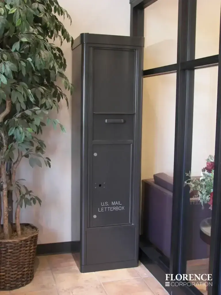 versatile™ 4C collection box in dark bronze installed in matching powder coat freestanding depot cabinet located in commercial building lobby