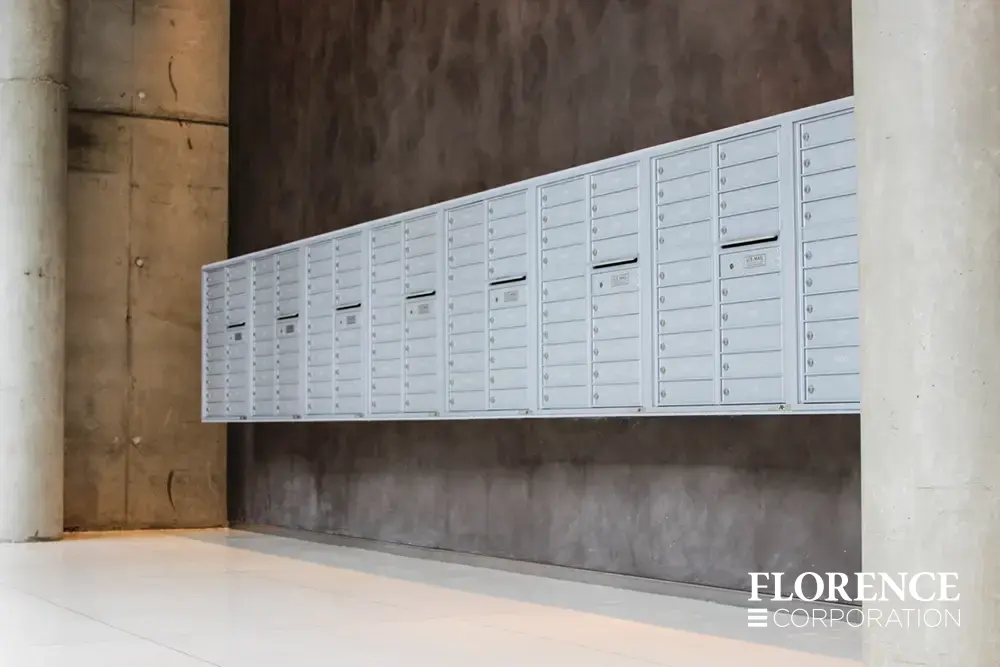 row of surface mounted versatile™ 4C mailboxes in silver speck mounted on dark wall in lobby of multifamily residential apartment hi-rise building in downtown Chicago