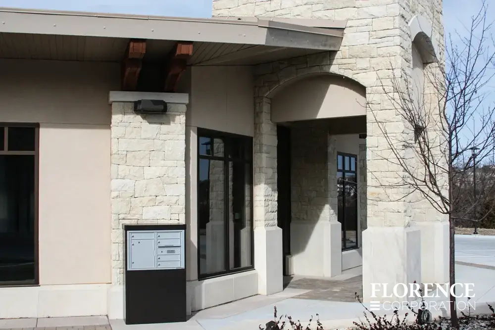 versatile™ 4C mailbox installed in freestanding depot cabinet outside of limestone commercial building in mid winter